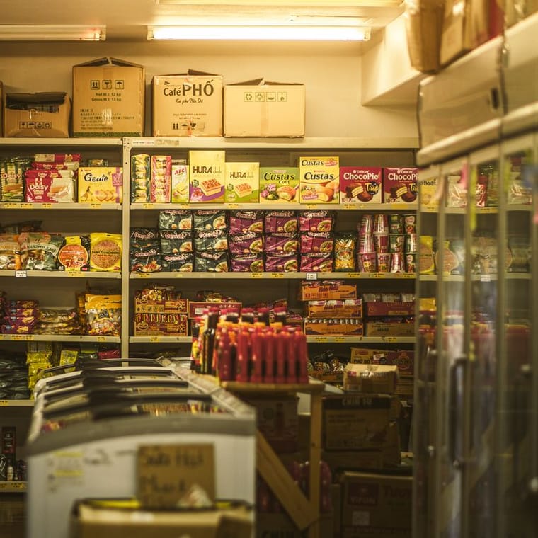 Packed shelves of boxed and packaged food in a shop